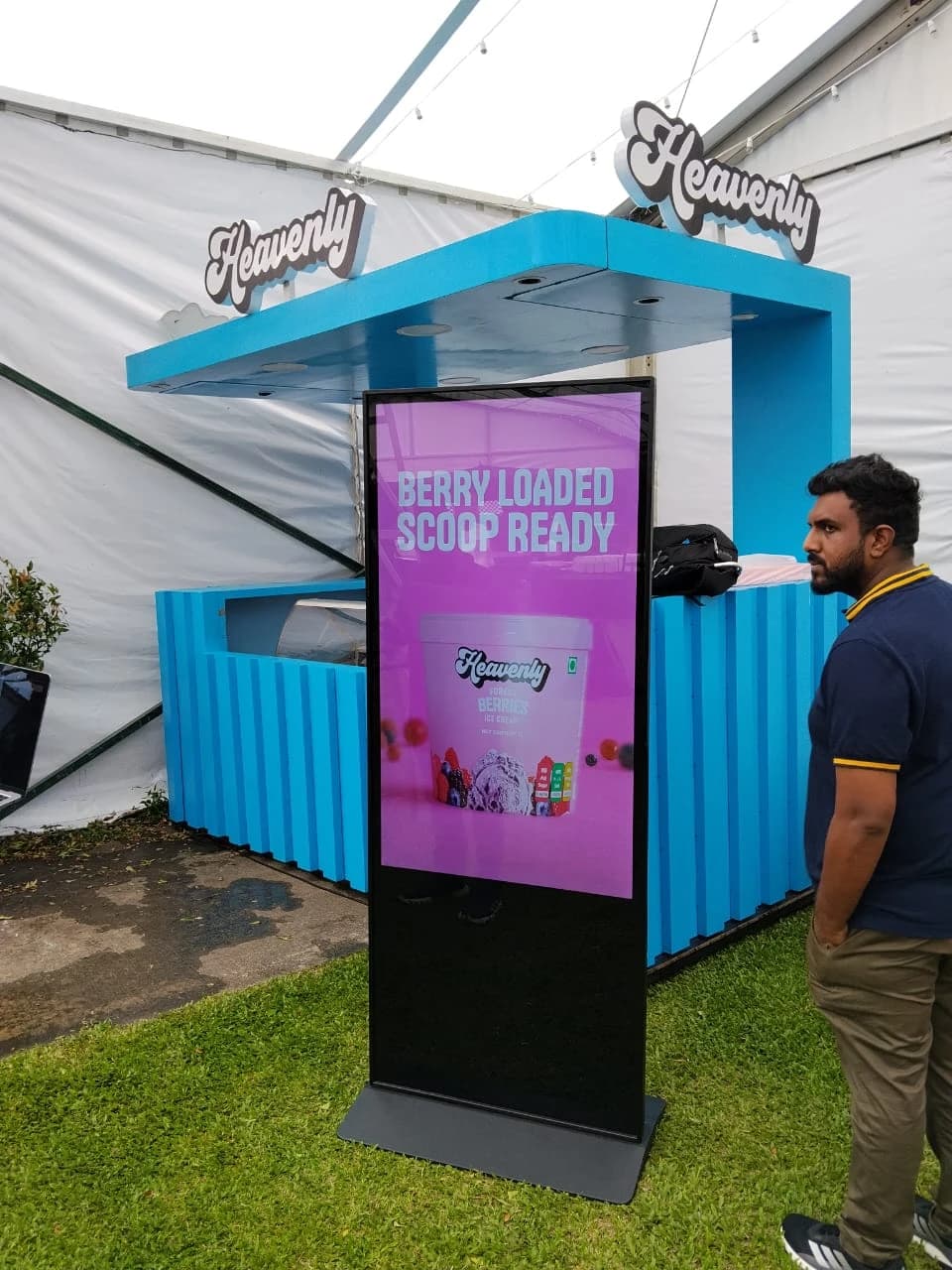 55 inch vertical advertising kiosk showing branded content at an outdoor event - Rentitem.lk